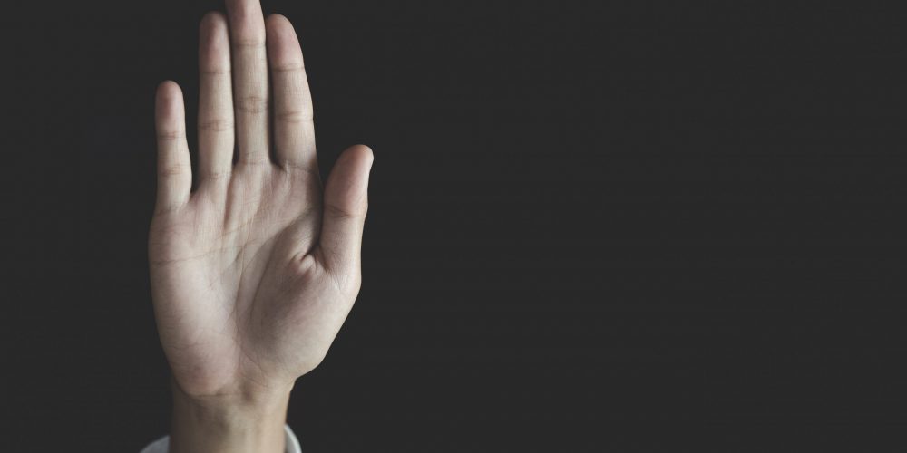 woman raised her hand for dissuade, The concept of stopping violence against women andand human trafficking, Stop sexual harassment and rape, International Women’s Day