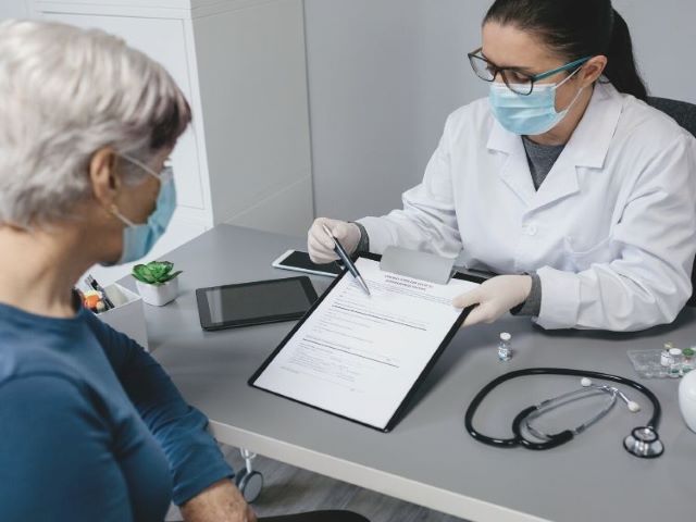 nurse showing patient consent form