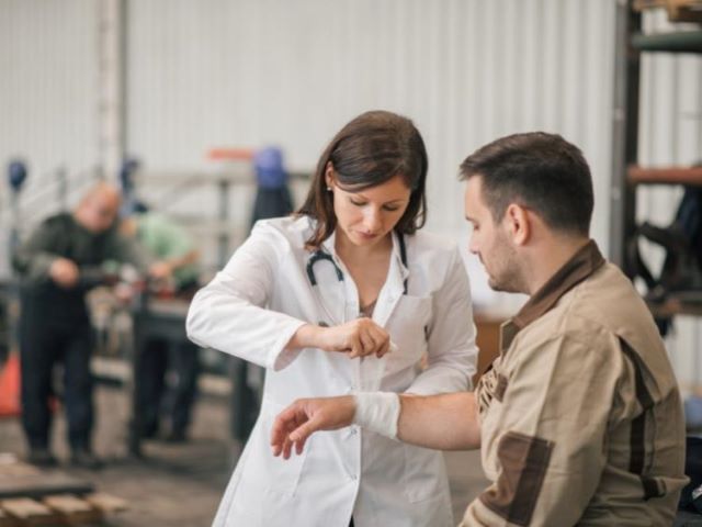 industrial nurse assisting employee with injury